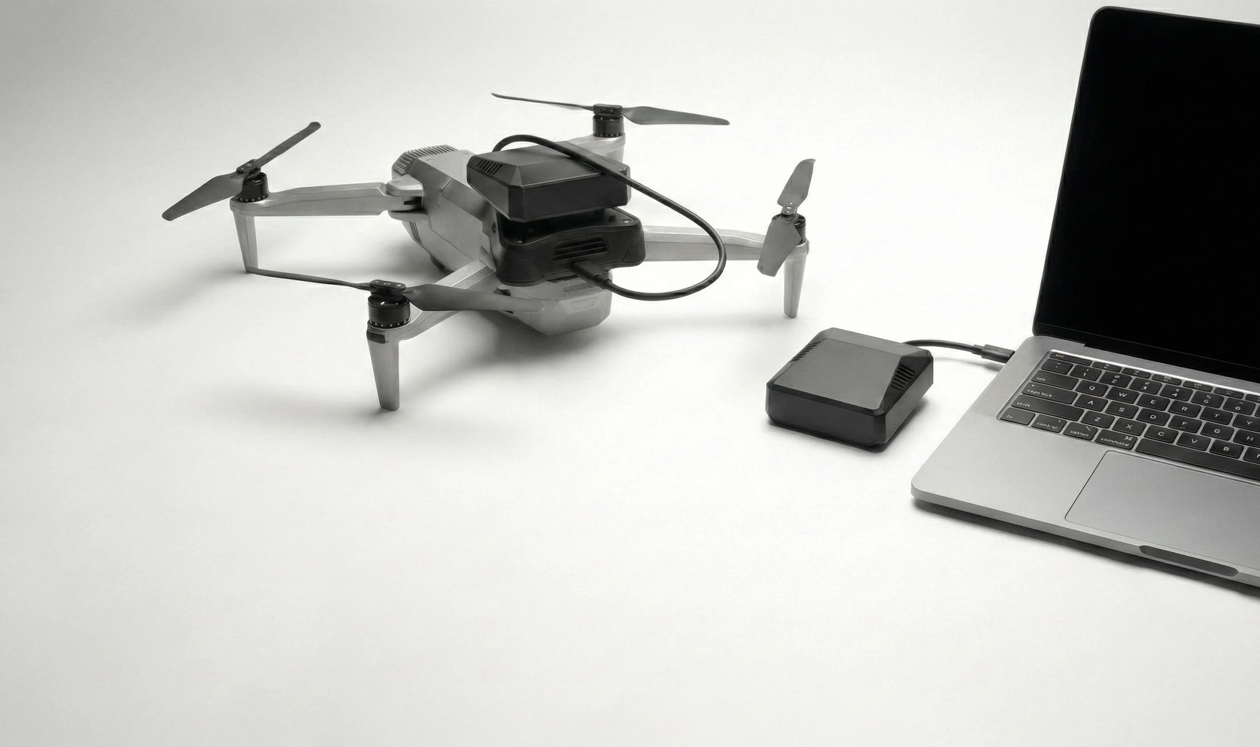Modusware AI device with drone and MacBook